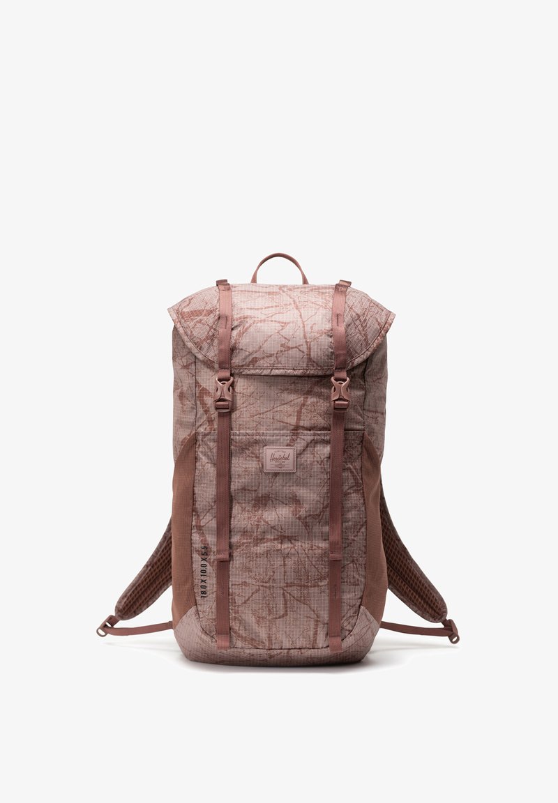 Backpack with a pink and brown patterned fabric, roll-top design, adjustable straps, and a front pocket with a logo patch. Textured accents.