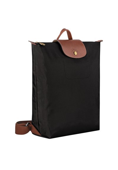 Black backpack made of durable fabric with a brown textured leather flap and handle, featuring a gold button closure and adjustable strap.