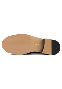 Black shoe sole with a smooth tan rubber base, featuring ridges for grip and a matte black accent on the heel. Size 37 indicated.