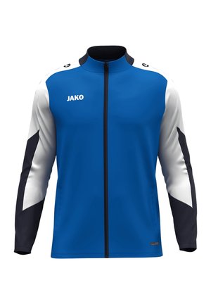 Giacca sportiva blu con maniche bianche e nere, chiusura a zip completa, colletto alto e logo JAKO sulla parte anteriore. Tessuto liscio, vestibilità atletica.