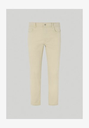 Beige puuvillachinohousut suoran lahkeen, tavallisten taskujen ja etupainikkeen suljennalla. Suora rakenne ja klassinen muotoilu.