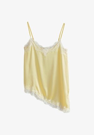 Caraco en satin jaune clair avec bordure en dentelle blanche sur le haut, le bas et l'ourlet asymétrique, avec fines bretelles doubles.