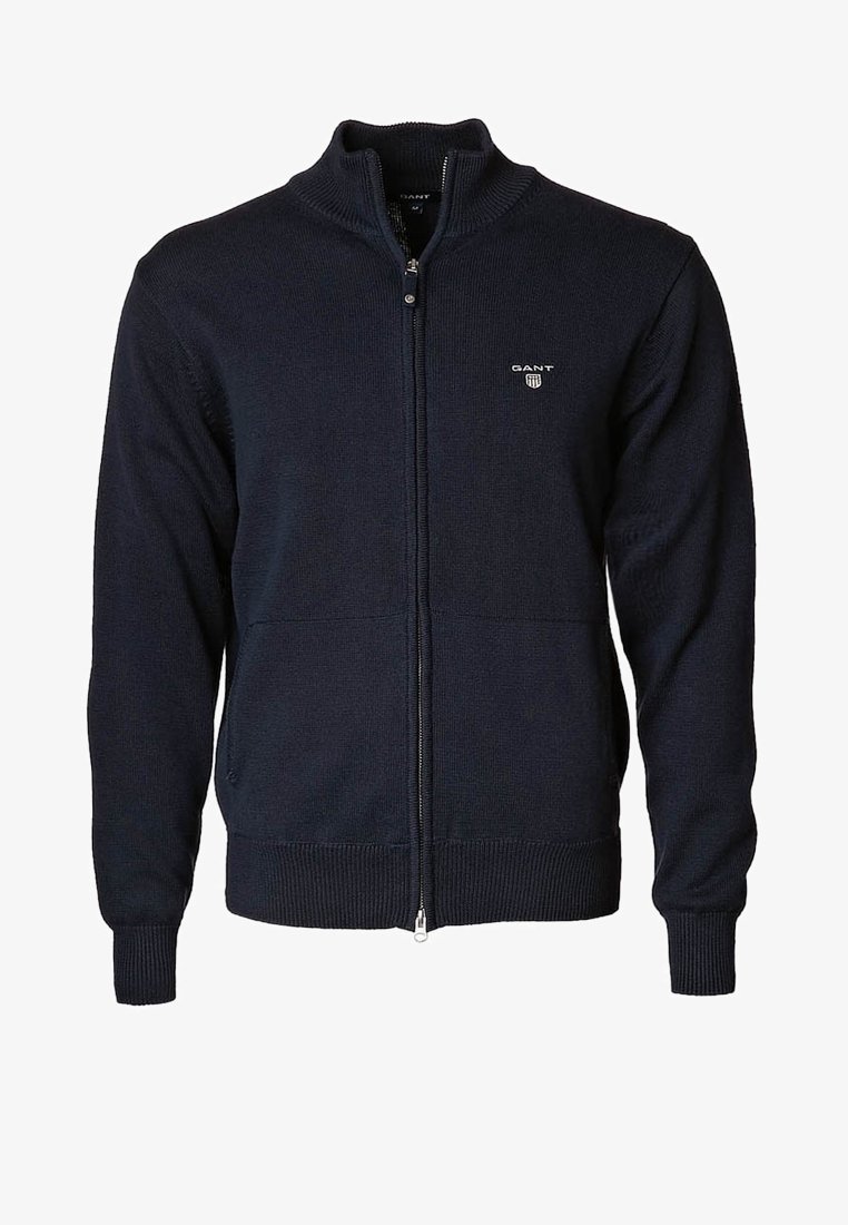 Navy blue knitted zip-up cardigan with ribbed cuffs and hem, standing collar, and small GANT logo on left chest.
