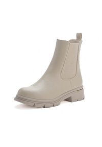 Stivale alla caviglia beige realizzato in materiale sintetico liscio, con pannelli laterali elasticizzati, una suola texture e un piccolo accento dorato sul tallone.