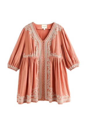 Peach-colored long-sleeve blouse with white floral embroidery, button front, gathered waist, and elastic cuffs.