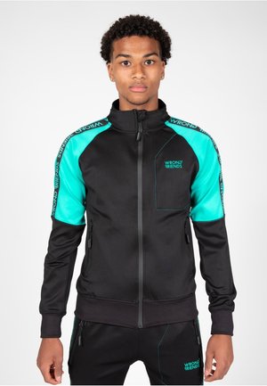 Zwarte sweater met ritssluiting en turkooisaccenten op de schouders en mouwen. Voorzien van een logo, ritszakken en een slank, getailleerd design.