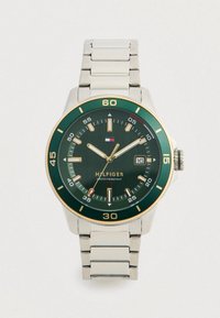 Silver stainless steel band watch with a green dial, gold accents, and a date window; features bold hour markers and luminous hands.