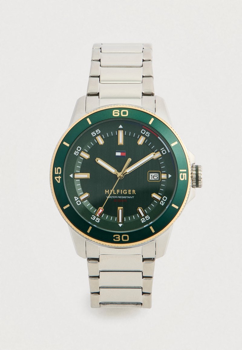 Silver stainless steel band watch with a green dial, gold accents, and a date window; features bold hour markers and luminous hands.