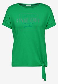 Grøn kortærmet T-shirt med rund halsudskæring, knyttet detalje ved kanten og dekorativ tekst med rhinsten i en kontrasterende blå farve.