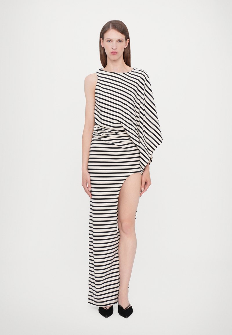 Striped maxi dress featuring a one-shoulder design, high side slit, and soft fabric in black and beige tones. Notable draping detail at waist.