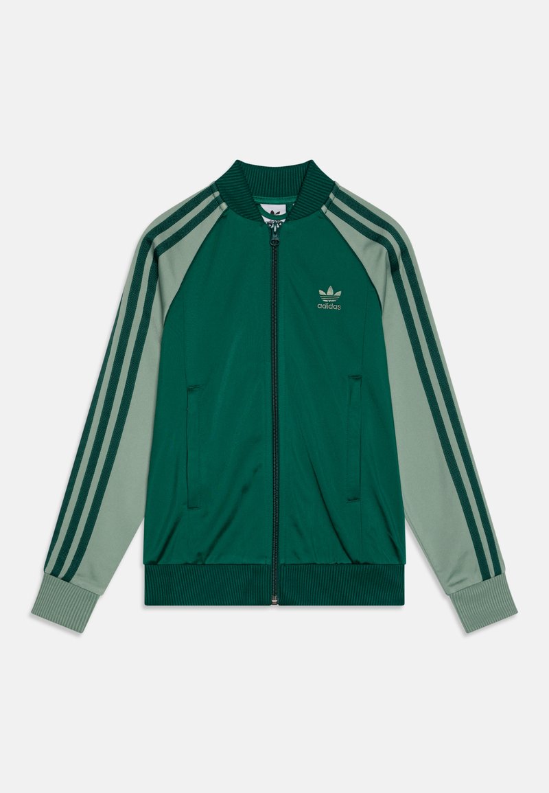 Zeleno in svetlo zeleno zip-up jakna z rebrastim ovratnikom, dvema stranskima žepoma in tremi vodoravnimi črtami na rokavih. Adidasov logotip na prsih.