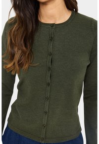 Tume roheline, ribadega pikkade varrukatega kardigan ümarate kaelustega ja nööbiga ees. Tekstuuriga kangas tumedate nööpidega.