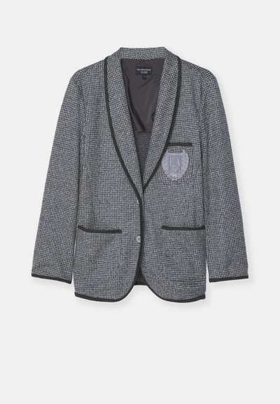 Blazer à carreaux gris avec garniture noire, fermeture à bouton unique, poche avec badge brodé et tissu texturé pour un détail supplémentaire.