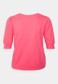 Fuchsia pink cotton T-shirt featuring puffed three-quarter sleeves and a round neckline. Smooth texture with a straight cut at the hem.