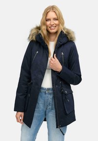 Navy parka with faux fur hood, zipper and snap pockets, drawstrings at waist, and a water-resistant material. Casual fit, medium length.