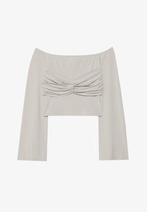 Top bez rukava u svijetložutoj boji, sa naboranim prednjim detaljem, dugim rukavima i izrađen od glatkog, rastezljivog materijala.