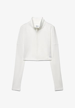 Giacca bianca corta con zip, colletto alto, maniche lunghe e cuciture piatte; presenta un logo circolare sul lato inferiore destro.