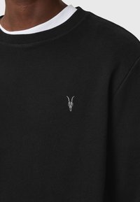 Black sweatshirt in cotton blend, featuring a ribbed crew neck and a small silver embroidered skull design on the chest.