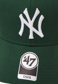 Green cap with white embroidered "NY" logo. Features a textured fabric and a tag stating "47" and "OSFA" near the brim.
