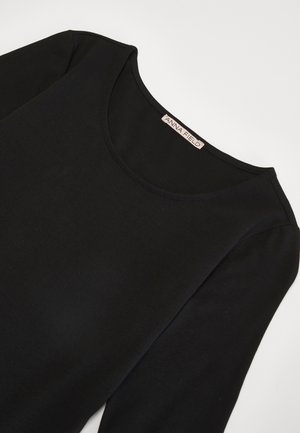 Black long-sleeve top with a rounded neckline, made of smooth fabric. Includes a label with text "ANNA FIELD" inside the neckline.
