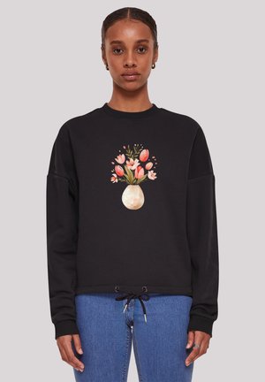 Black sweatshirt featuring a front floral design with tulips and a vase. It has a relaxed fit, ribbed cuffs, and drawstring at the hem.
