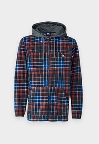 Fleece zip-up hoodie met een geruit patroon in rood, blauw en zwart. Het heeft een grijze capuchon, zakken aan de voorkant en een logo op de borst.