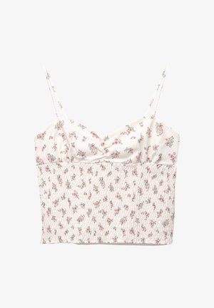 White floral crop top with thin adjustable straps, featuring a gathered texture and small pink and green rose patterns throughout.