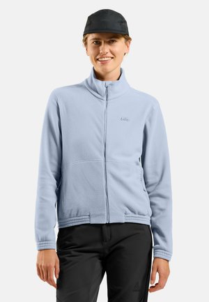 Light blue fleece jacket with a high collar, zip closure, and side pockets. Features a subtly embossed logo and ribbed hem detail.