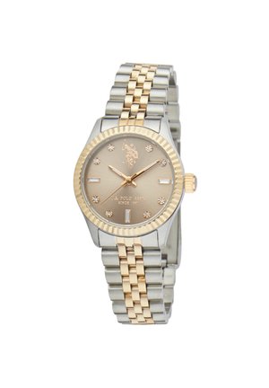 Montre-bracelet en métal bicolore avec maillons dorés et argentés, lunette dorée, cadran champagne avec index des heures en cristal et trois aiguilles dorées.