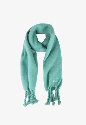 Écharpe turquoise en tissu doux ; présente des franges tressées aux extrémités et un logo "LC" brodé. Surface texturée avec des détails subtils.