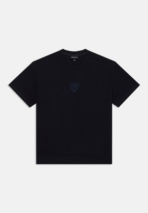 Camiseta de algodón negra con cuello redondo, mangas cortas y un logo de triángulo bordado en azul marino oscuro en el pecho.