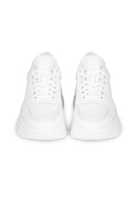 White sneakers featuring a textured finish, lace-up design, padded collar, and thick rubber sole, front view showcasing symmetry and clean lines.