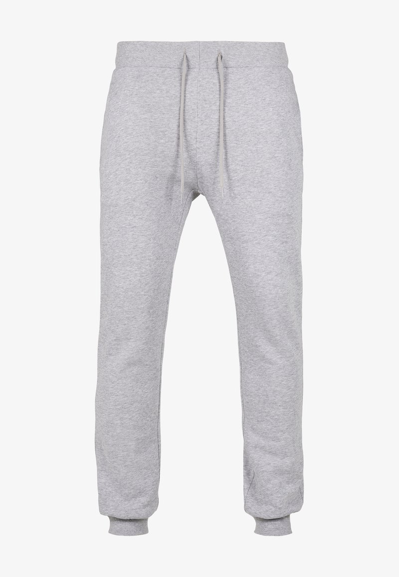 Graue Jogginghose mit Kordelzugbund, Rippbündchen, weichem Stoff und schmal zulaufenden Beinen. Keine sichtbaren Muster oder Akzente.