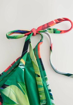 Roheline bikini ülaosa, millel on erksavärvilised lillemustriga nöörid, sile tekstuur ja õmblustega servad. Kujundus sisaldab reguleeritavaid rihmasid.