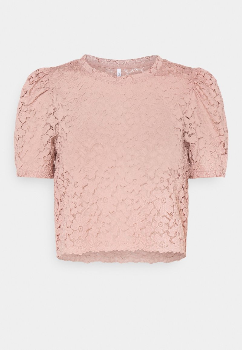 Blouse rose en dentelle à manches courtes avec un motif floral, encolure ronde et manches légèrement bouffantes, présentée sur un fond blanc.