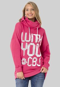Rosa Kapuzensweatshirt mit Schlauchkragen, ausgestattet mit auffälligem weißen Text. Lange Ärmel und gerippte Bündchen, lockere Passform, weiches Baumwollmaterial.