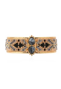 Bracelet jonc ton or avec un travail de perles complexe en noir, argent et bronze. Il présente deux pierres en forme de goutte d'eau au centre avec des accent décoratifs.