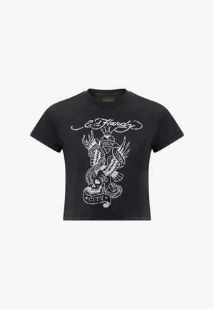 T-shirt noir court en coton, présentant un design graphique gris avec un crâne, un serpent et des ailes, portant l'inscription "New York City."