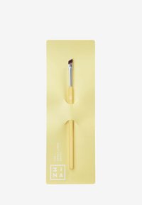 Keltainen kulmaliitännäissivellin, jossa on hopeanvärinen sydän ja hienot siveltimen harjakset, esitelty vastaavassa keltaisessa pakkauksessa brändäyksellä.