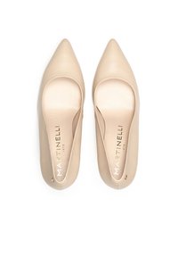Nude leather pointed toe slip-on shoes with rounded cutouts and gold branding on the insole. Smooth texture and minimalist design.