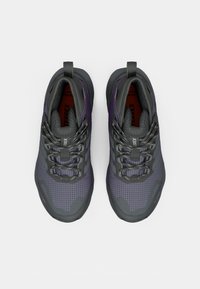 Gray and purple athletic shoes with mesh and synthetic materials, featuring a grid pattern, textured accents, and black laces.