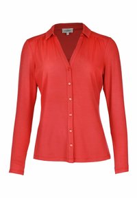 Red long-sleeve blouse with a button-up front, collar, and fitted silhouette. Smooth texture, featuring matching buttons along the placket.