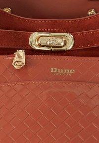Brown woven leather handbag featuring gold hardware, a zip closure, and a logo embossed on the front, with a soft suede strap.