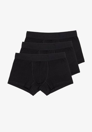 Tři páry černých boxerek vyrobených z měkké tkaniny, které mají těsný střih, elastický pas a detail v oblasti otevření vpředu.