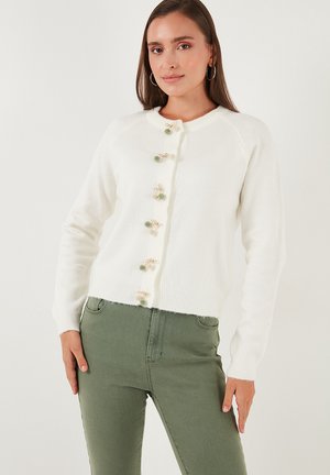 White, wool-blend cardigan with a round neck, ribbed hem, and decorative buttons featuring small green and gold accents. Long sleeves, fitted style.