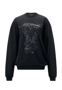 Czarna bluza z bawełny, z dużą grafiką na przedzie przedstawiającą orła, czaszkę i tekst. Żeberkowe mankiety i dekolt. Luźny krój.