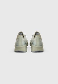 Sneakers verde chiaro con tomaia testurizzata, colletto imbottito e suola in gomma spessa. Presenta dettagli riflettenti e una suola testurizzata per una migliore aderenza.