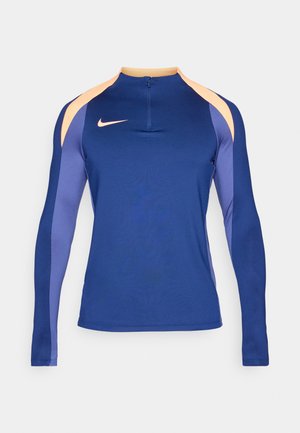 Langarm sporttop in diep marineblauw, met lichtoranje en paarse schouderpanelen, halve rits en een nauwsluitend ontwerp.