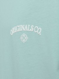 T-shirt vert menthe à manches courtes avec le texte brodé en blanc "ORIGINALS CO." et un motif géométrique en forme de diamant sous le texte.