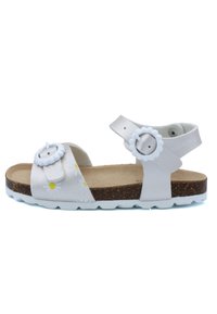 Sandale blanche ornée de motifs floraux, dotée de deux boucles réglables, d'une semelle en liège et d'une semelle extérieure blanche. Conçue pour le confort et la durabilité.